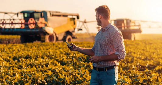 farmer using smartphone to control irrigation pump in field
