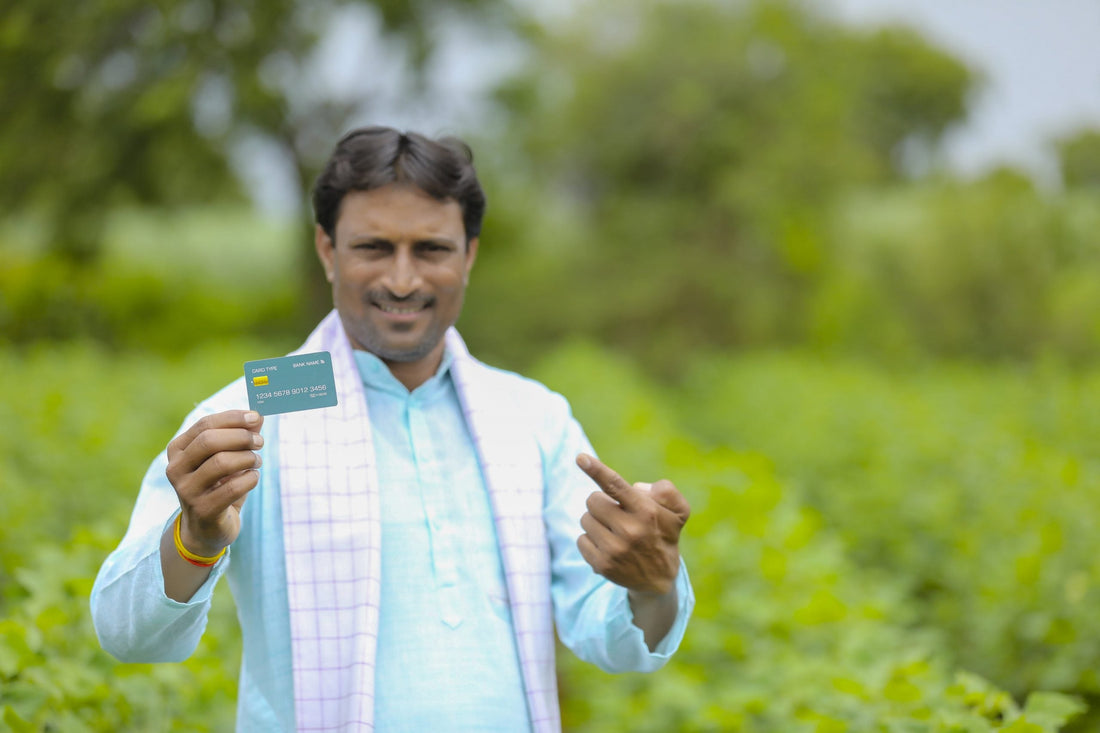 indian farmer holding kisan credit card document field