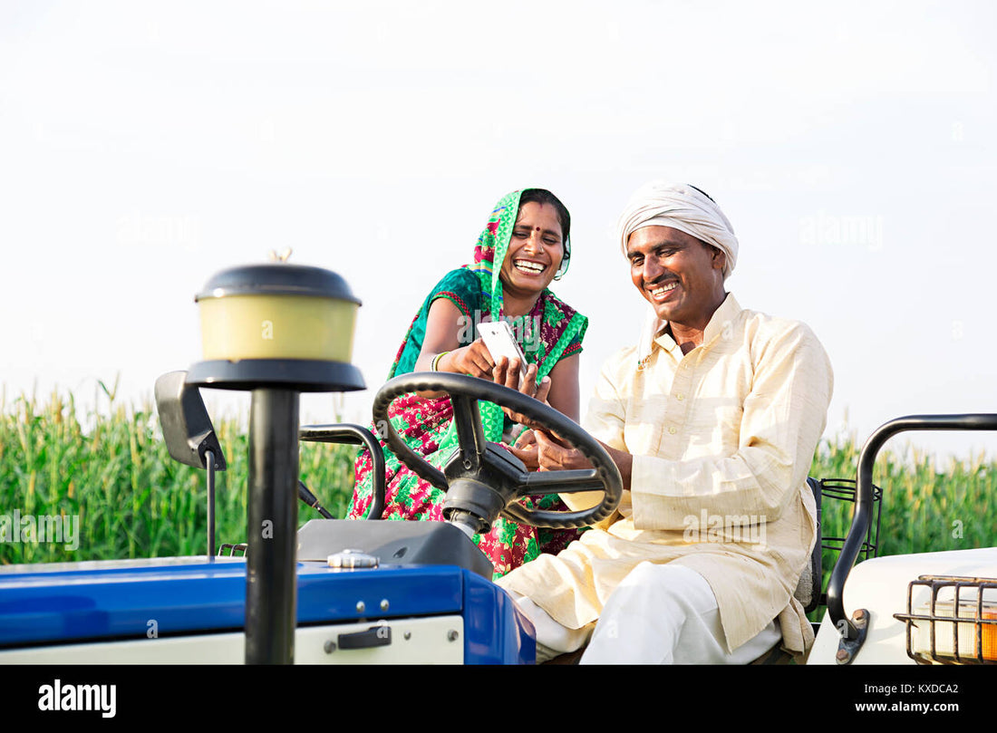 Indian farmer laughing on a tractor field
