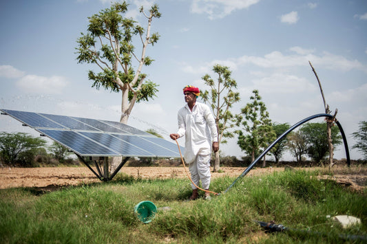 Indian farmer installing solar pump on field