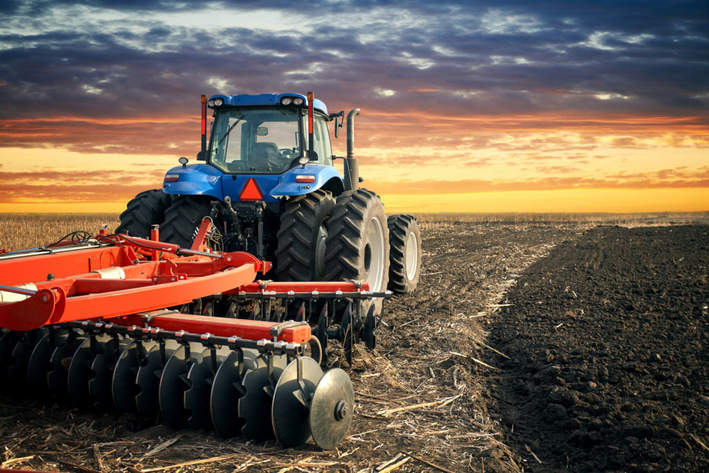 tractors with agricultural implements in field